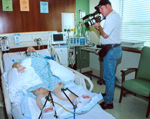Woman in hospital bed being filmed for a Day in the Life legal video for a personal injury case.